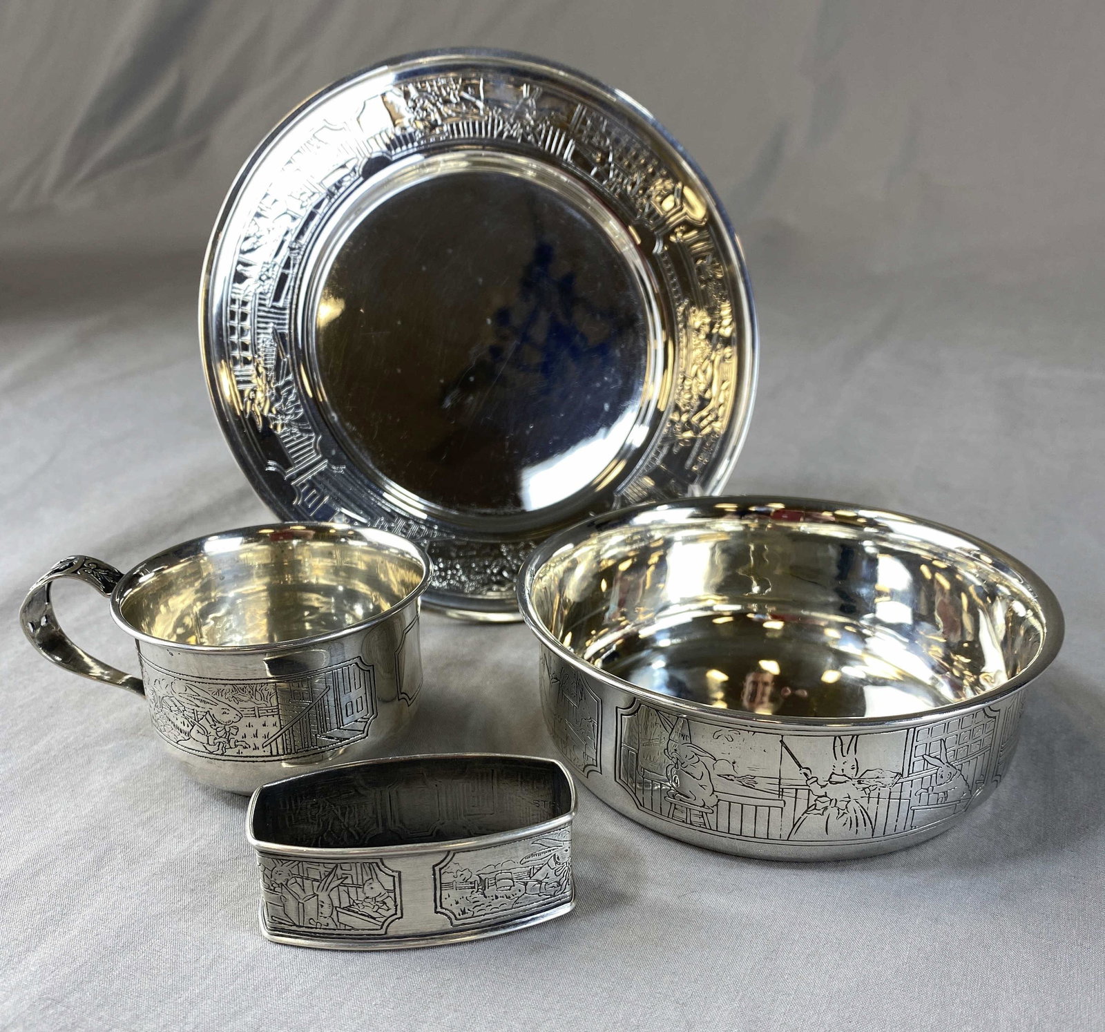 Webster Sterling Bunny 4 Piece Nursery Set: From Webster Sterling, a 4 piece nursery set in in a Peter Rabbit or bunny design. It includes a 5 3/4" plate weighing 72 grams, a 4 1/4" diameter bowl weighing 69 grams, a 1 1/2" tall cup weighing 28