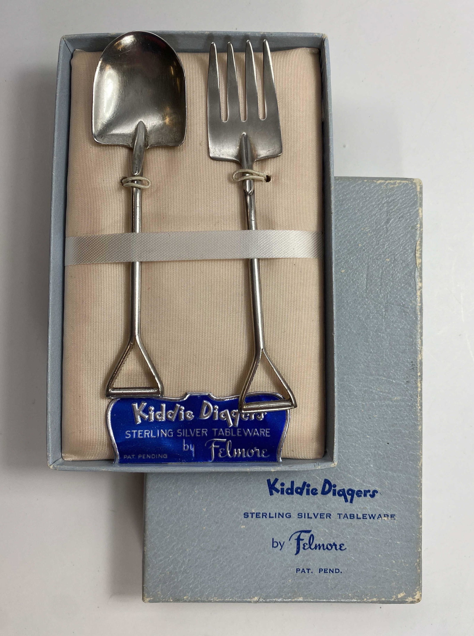 Kiddie Diggers Sterling Children's Flatware: Sterling silver children's tableware by Felmore. A spoon and fork in the shape of a shovel and pitchfork in its original box.