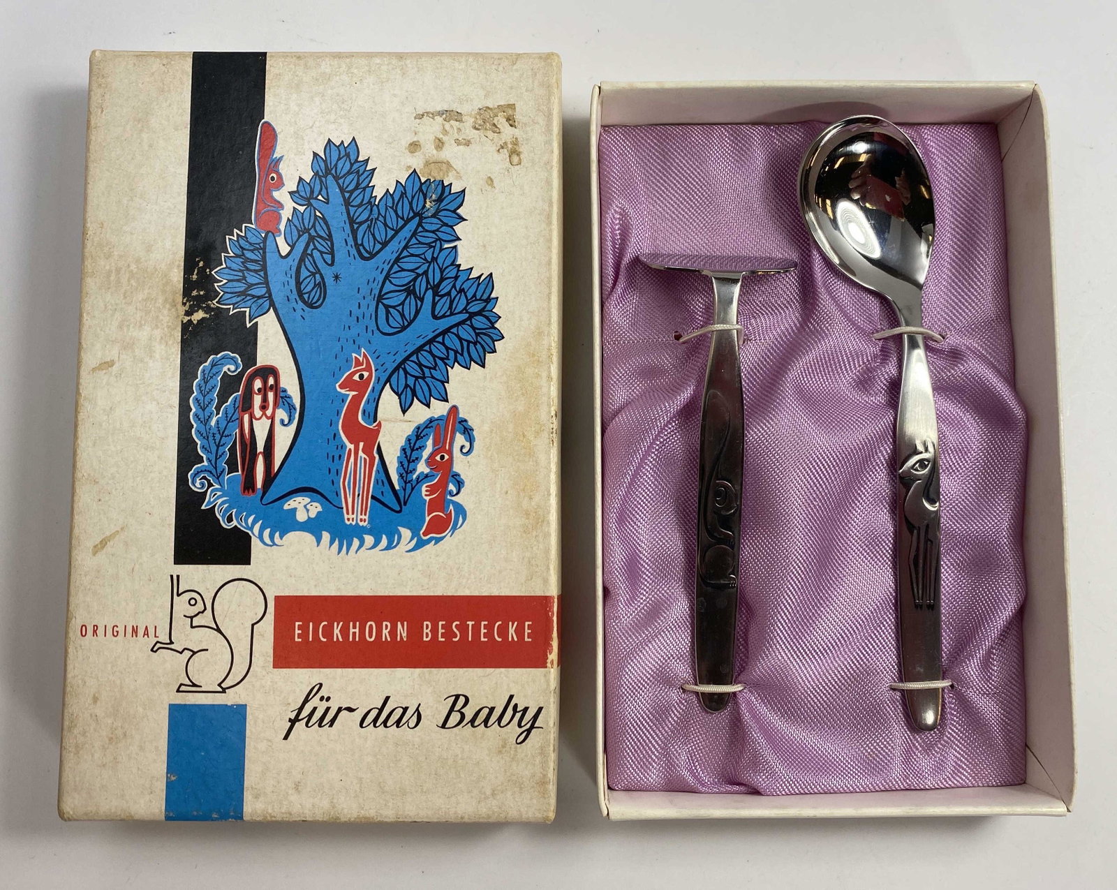 Midcentury Carl Eickhorn Baby's Flatware Set: A midcentury modern stainless steel set from Carl Eickhorn Germany. Includes a spoon and food pusher. Comes in its original box.