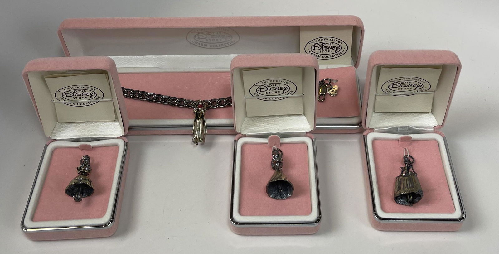 Sterling Disney Charm Collection Bracelet & Charms: Group of 4 numbered Limited Edition Disney Charm Collection charms and bracelet in sterling silver. Includes: - 4 Numbered Limited Edition Disney charms, Snow White, Cinderella, Sleeping Beauty and Al