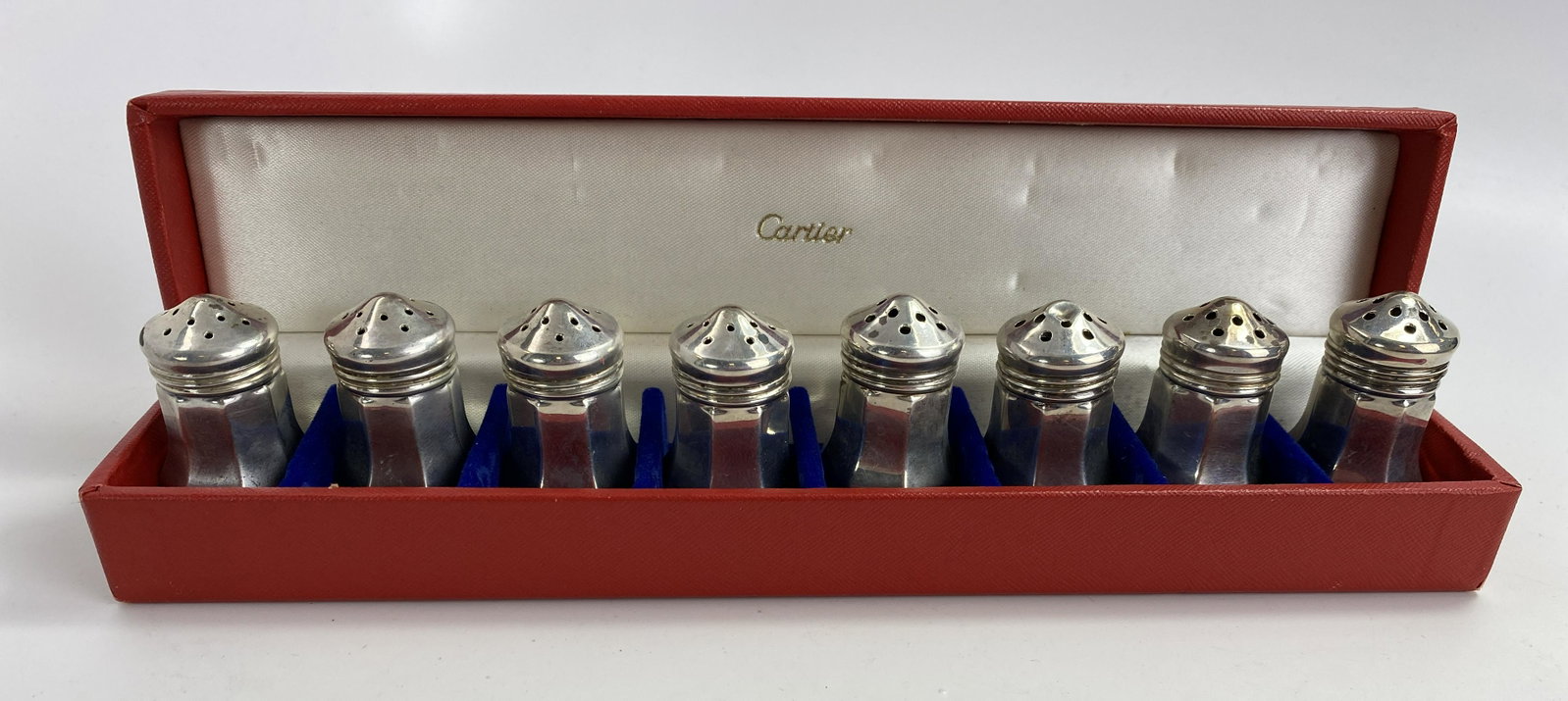 8 Cartier Sterling Silver Salt and Pepper Shakers: A set of 8 individual sterling silver salt and pepper shakers (4 of each) from Cartier. Each measures 1 1/2" tall and the total combined weight of all 8 is 59 grams.