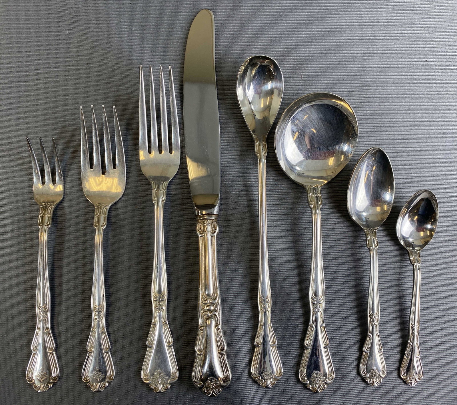 Eldan Japan Nickel Silver Flatware Service for 12: Mid 20th century service for 12 marked nickel silver. Includes: 12 dinner knives, 12 dinner forks, 12 salad forks, 12 cocktail forks, 12 round cream soup spoons, 24 teaspoons, 12 demitasse spoons, 12 