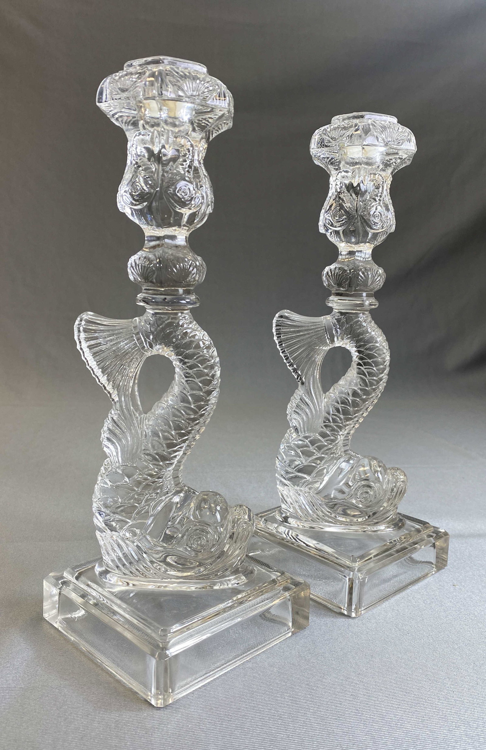 Pair Pressed Glass Dolphin Candlesticks MMA: A pair of Pressed glass dolphin candlesticks from the Metropolitan Museum of Art. Marked as shown. Height 11".