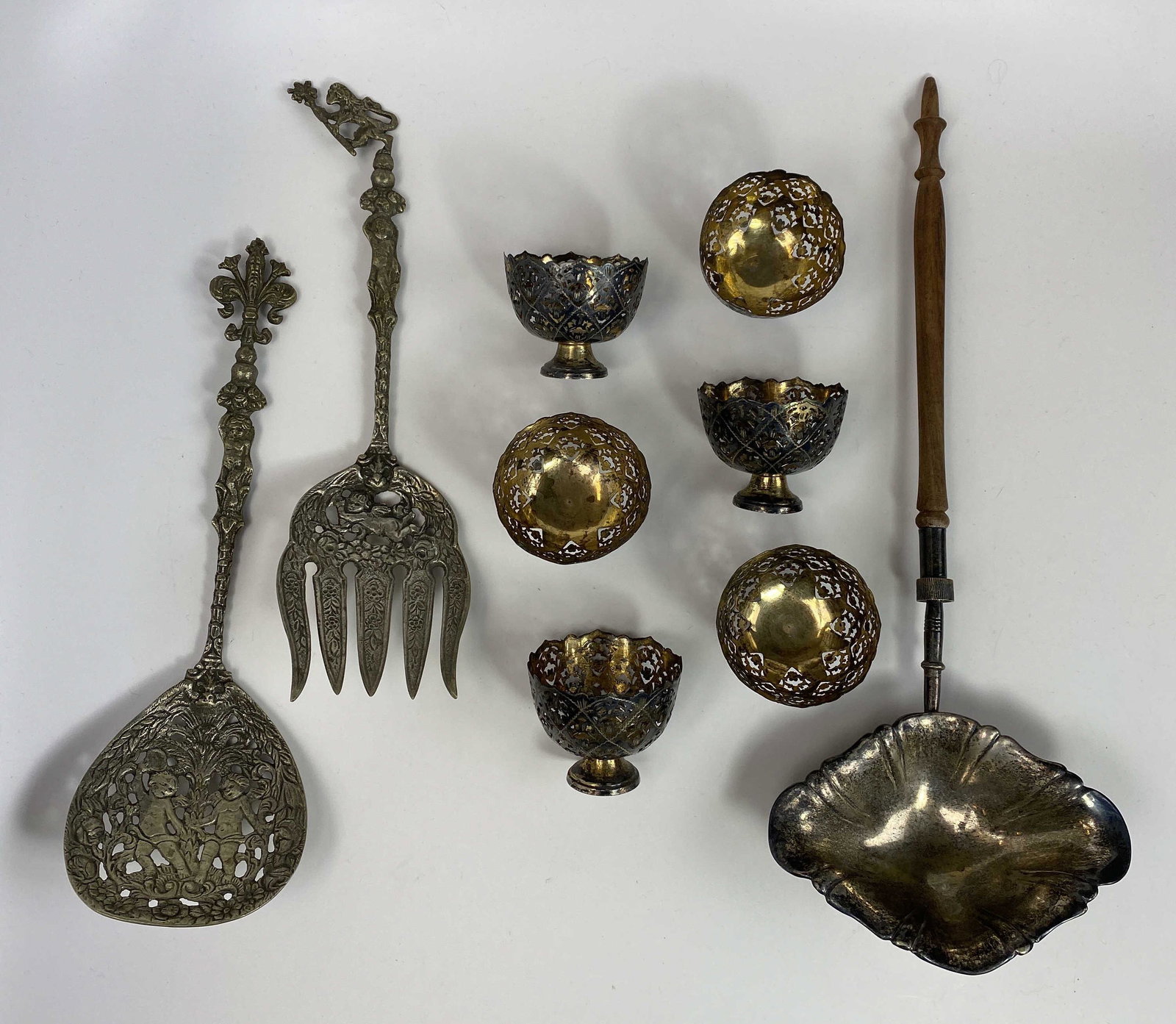 Group of Intricate Antique Silver Smalls: Includes: - A pair of embossed salad servers marked Italy. - 6 delicate pierced cups which appear to have a gilt wash over silver toned metal, they are unmarked. - An older ladle with a detachable tur