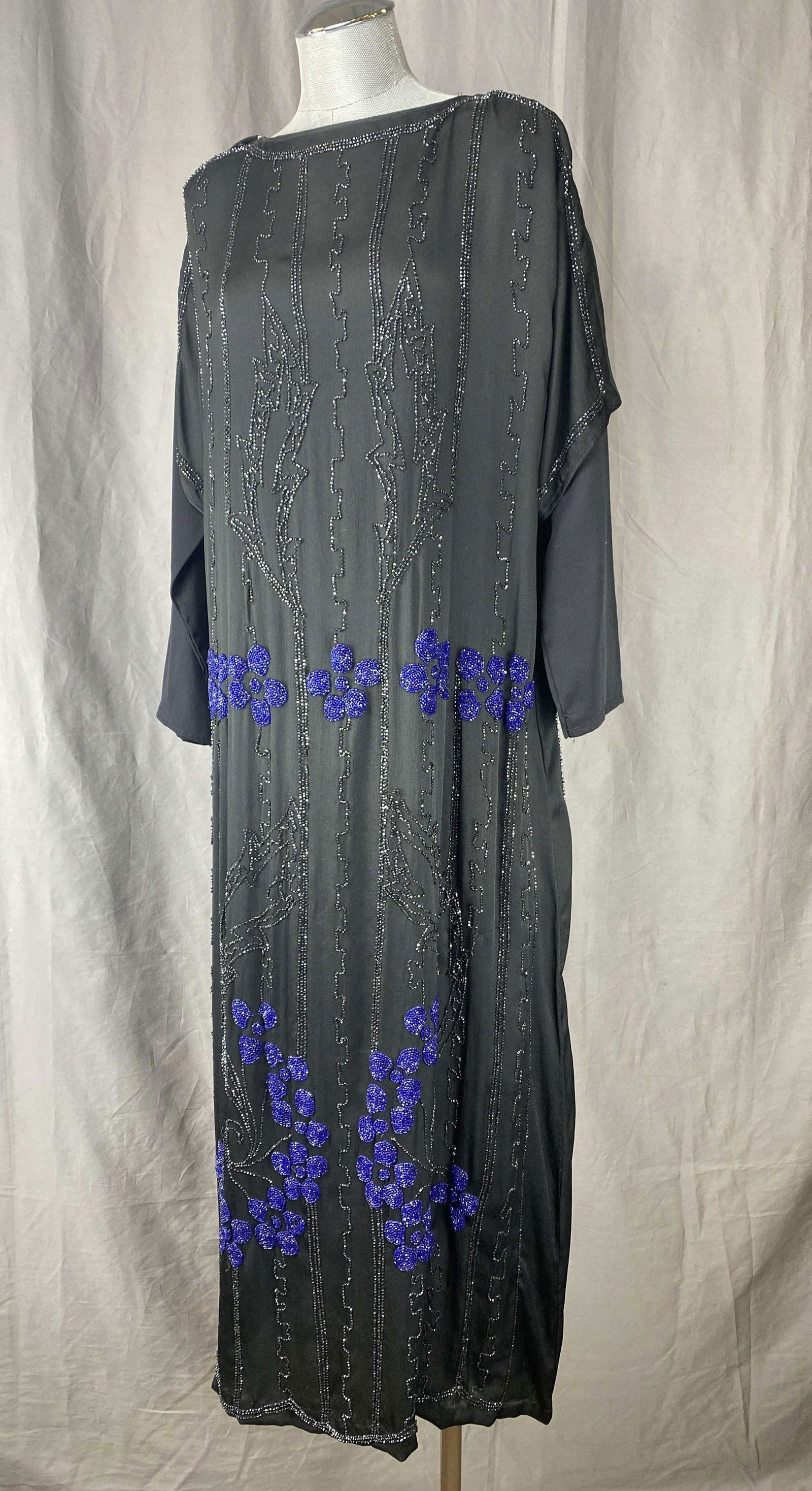 C. 1920s Cobalt Blue Beaded Black Silk Dress: Black satin finish silk heavily beaded in cobalt and metallic glazed black beads. It has split cap style short sleeves under which long sleeves in a slightly different fabric have been added. They cou