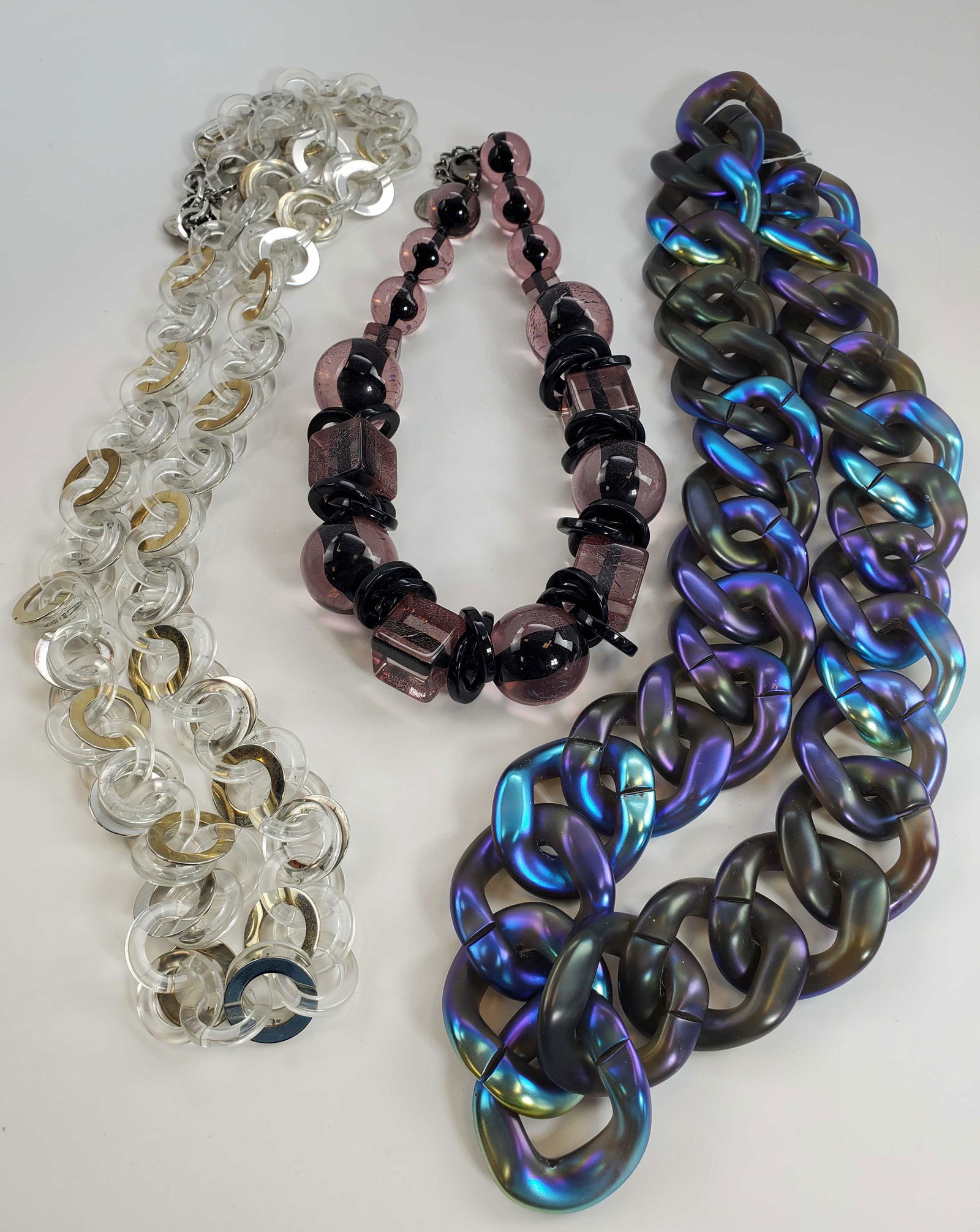 Pono By Joan Goodman Couture Necklaces: (1) purple iridescent large Italian Resin curbed linked necklace by Pono by Joan Goodman made in Italy 30". (1) clear Lucite with silver & gold tone accents linked necklace 40" and (1) large pink Luci