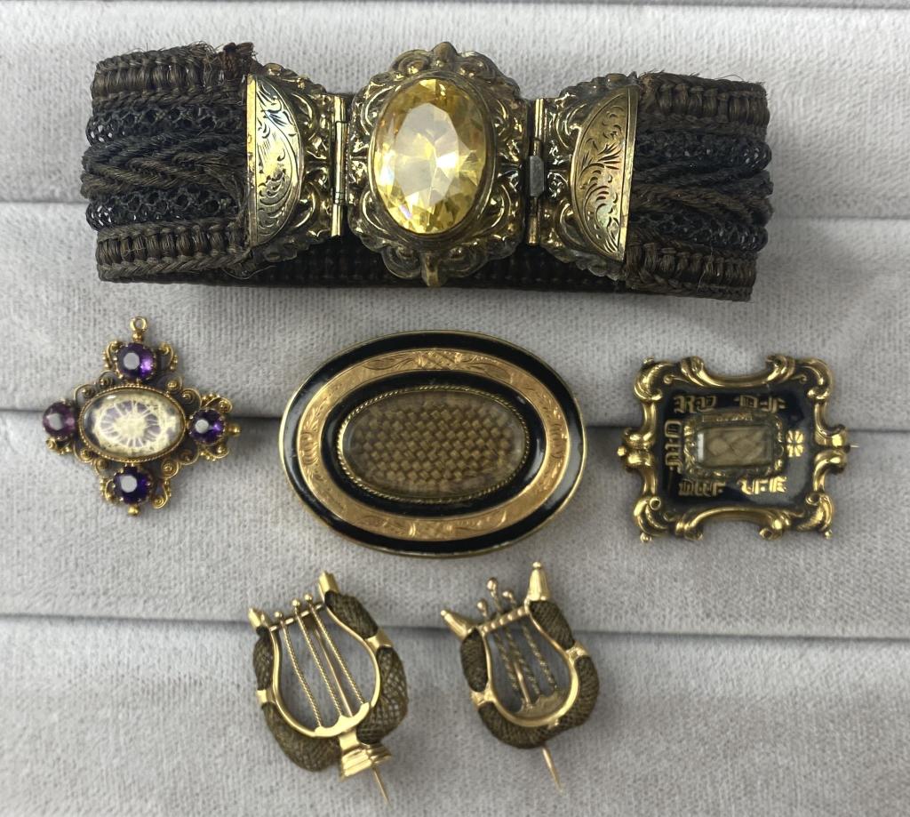 6 Pieces 19th Century Hair Mourning Jewelry: Includes one bracelet and five brooches. The gold settings are unmarked. One of the brooches is engraved and dated 1840. Shipping: In-House Shipping Offered