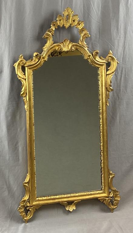 Carved Giltwood Mirror Italy Mid 20th Century: Hand carved and gilded in Italy with an intentionally distressed finish. Circa early to mid 20th century. Height 42-1/2" Width 22" Shipping: This item is not eligible for in-house shipping. It may be 