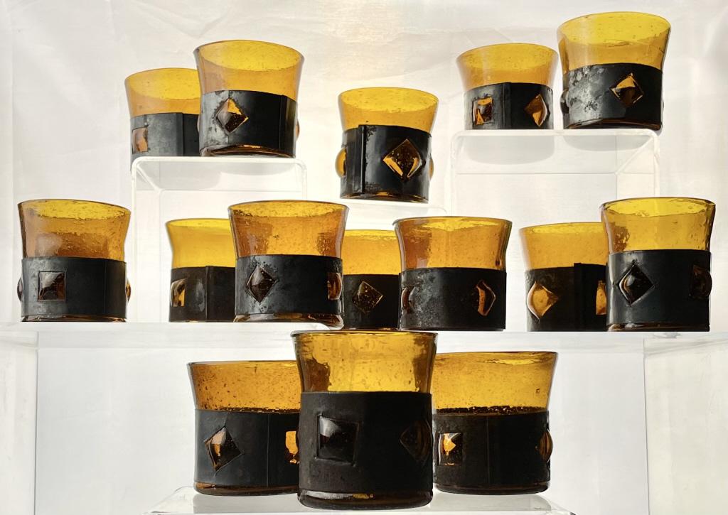 16 Brutalist Caged Glass Cups Felipe Derflingher: 16 midcentury Felipe Derflingher brutalist caged glass cups. Made in Mexico City in the 1960's. Amber glass with iron wrapping. Each cup measures approximately 3-1/2".