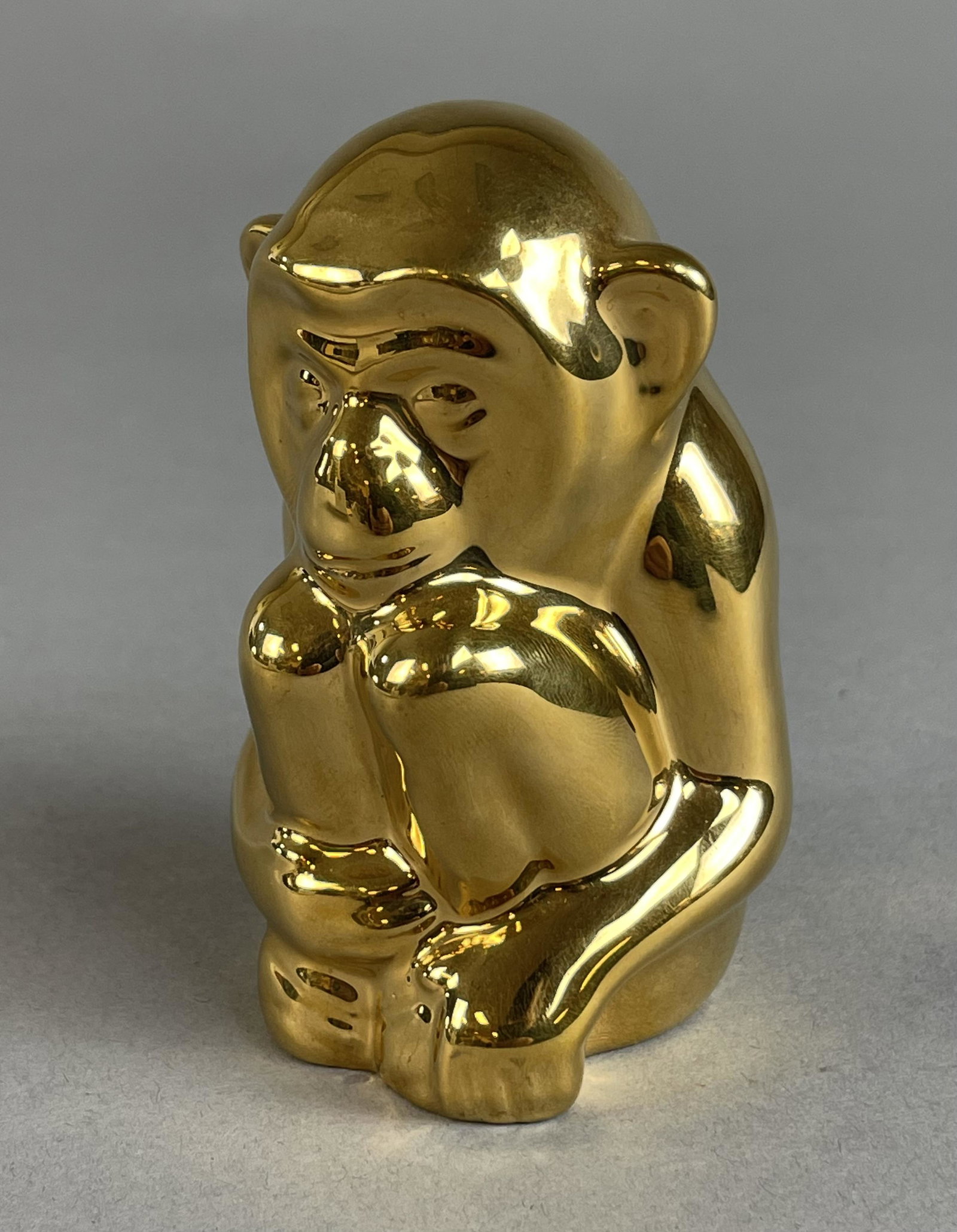Rookwood Pottery Present Day Golden Monkey: Finished in 24k gold. Numbered 465. Dated 1983. Height 3-3/4" Shipping: In-House shipping available for this lot. Please read the shipping section in our full Terms and Conditions for all information 