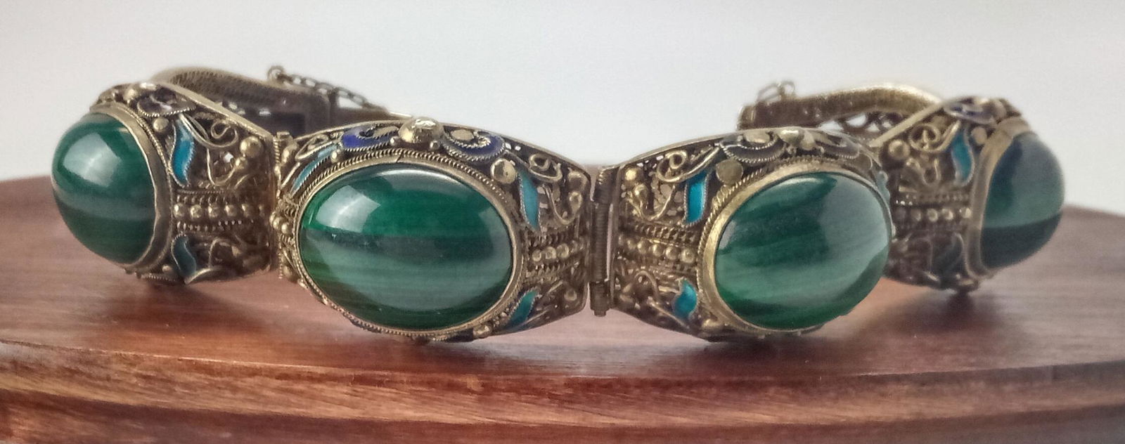 1920s Vermeil Filigree Malachite Bracelet: 4 Malachite cabochons in gold washed silver filigree with enamel accents. Measures 7" and is marked Silver. Shipping: In-House shipping available for this lot. Please read the shipping section in our