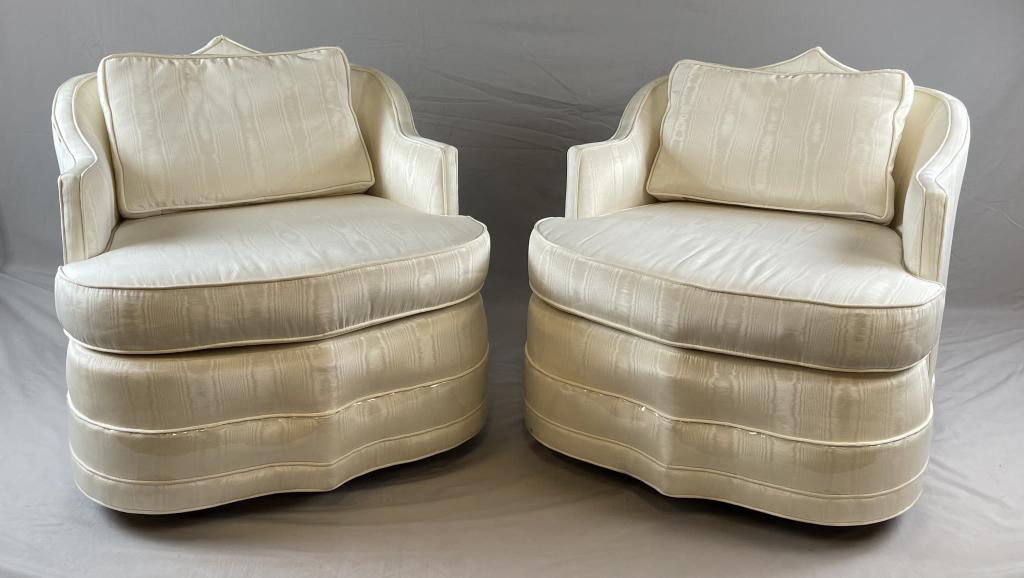 Two Swivel Chairs in the Style of James Mont I: Circa 1960s, a pair of midcentury modern Moorish influence swivel chairs in the style of James Mont. They are upholstered in white moire.There is a second pair available in the following lot. Height 2