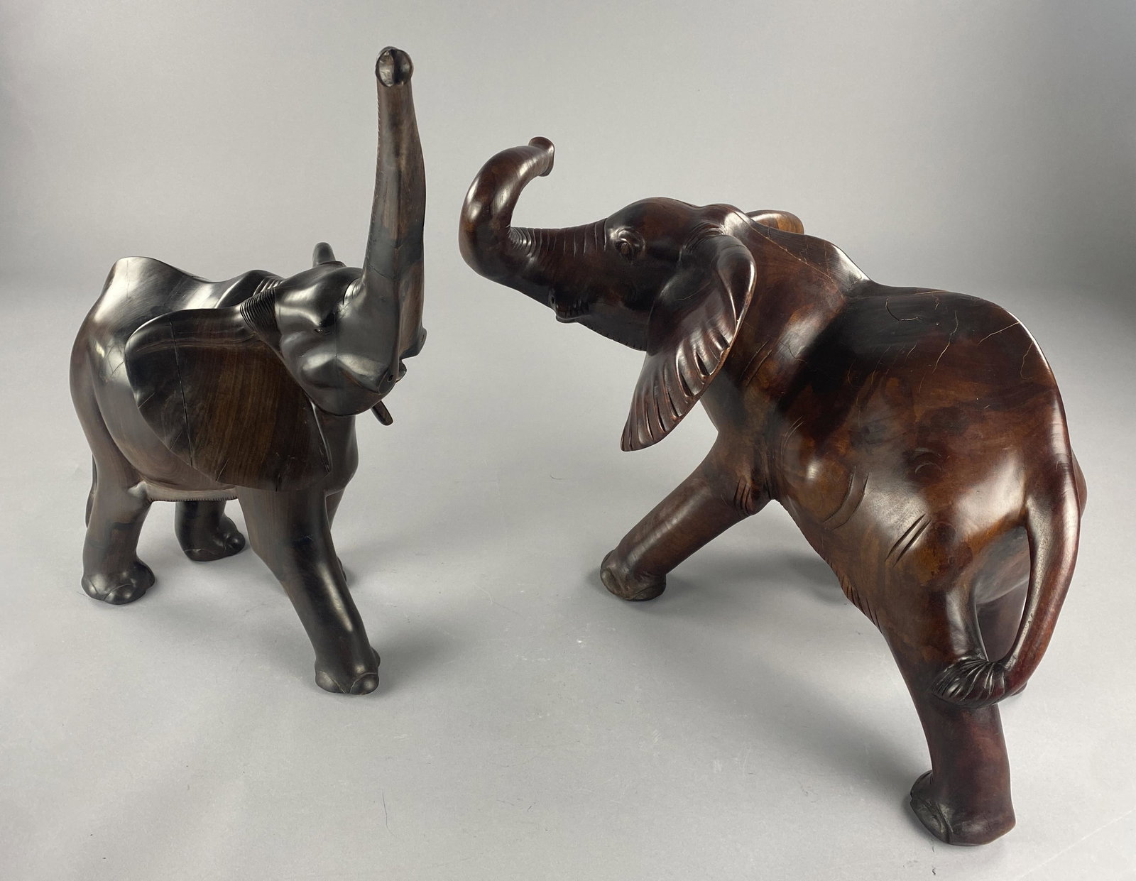 Pair Large African Elephant Ebony Carvings: Large and heavy hand carved pair, male and female in wood that appears to be ebony. Tallest measurement 21-3/4". Shipping: Local pick-up or 3rd party shipping only for this lot. Please see the Shippin