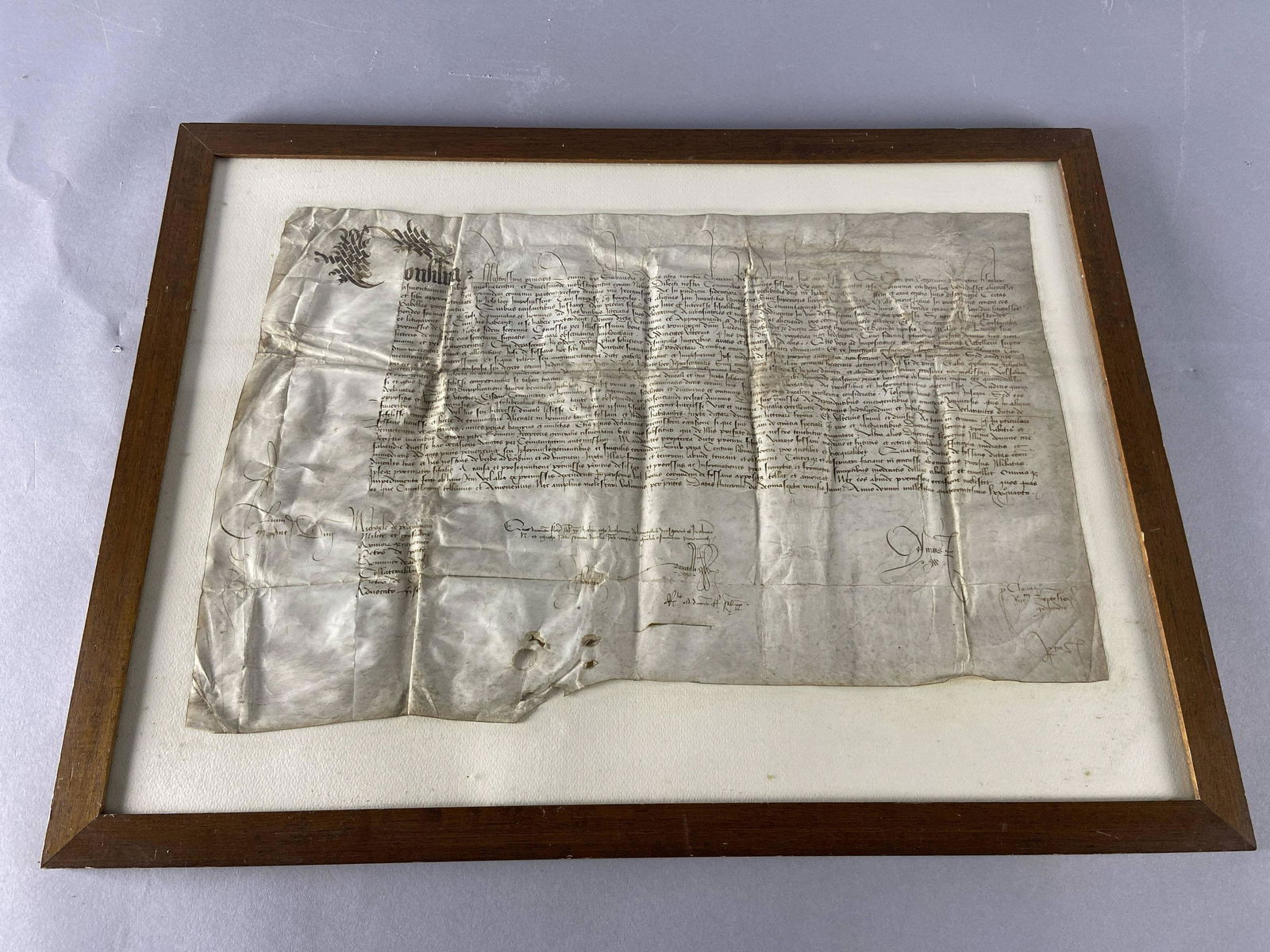 Medical Consilia in Frame Circa 1500: Framed document on linen parchment. Faint and written in Latin, I believe this to be a page from a Consilia circa 1500, as the first word appears to be Consilia. In frame, 19 X 25 1/2 inches in size.