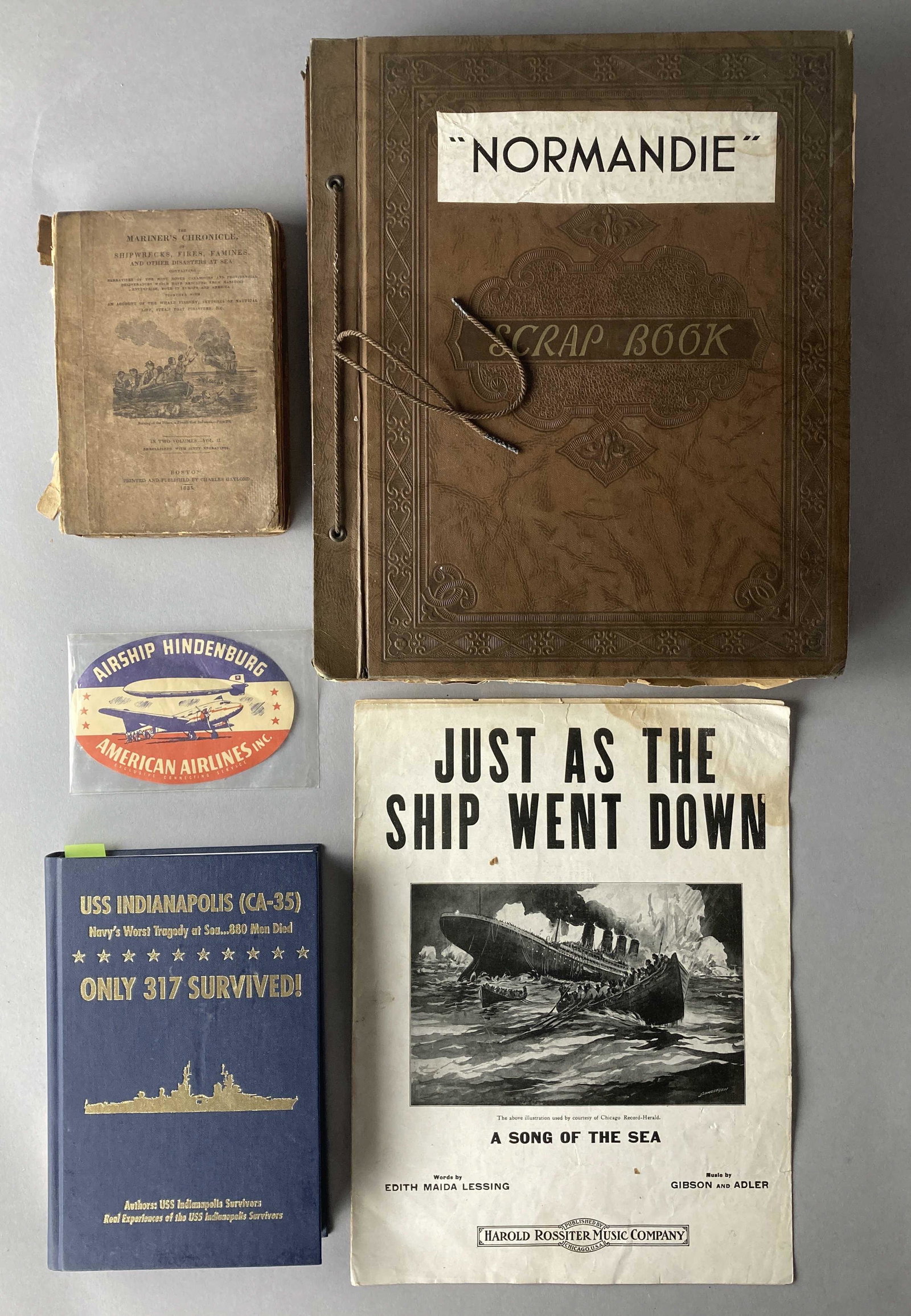Shipwreck and Disasters Books & Ephemera: Two books, one scrapbook, one sheet music pamphlet, and one sticker from disasters and shipwrecks. Just as the Ship Went Down by Edith Maida Lessing, music by Gibson & Adler published by Harold Rossit