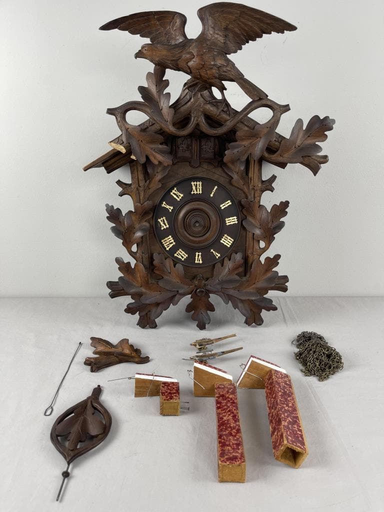 Eagle Motif Cuckoo Quail Clock Repair or Parts: 8 Day German Black Forest eagle and oak leaf motif cuckoo quail clock with some parts to have clock repaired. G.K. and 31 is stamped on movement. Comes w/ what is seen in the pictures. 21'' w/ gable.