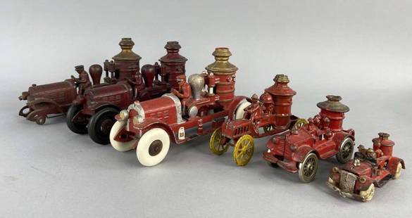 Six Cast Iron Fire Trucks: Three Kenton Cast Iron Fire Pumper Trucks from the 1930's, marked underneath Kenton Toys Canton Ohio. Smaller fire pumper truck with yellow wheels, possibly Hubley or Arcade, unmarked. Small red