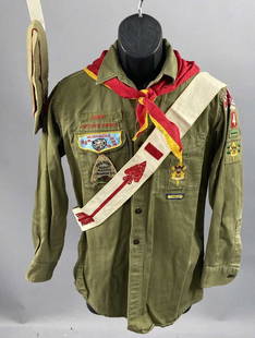 Four Piece 1960's Senior Boy Scout Uniform: Boy Scout shirt, hat, scarf, and Order of the Arrow sash. Badges and patches on shirt indicate that it was owned by a Senior Boy Scout in the 60's belonging to the Portage Trails Council of Michigan i