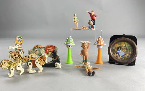 Ring a Lings, Circus Animals, Cake Toppers, Dolls: Two Ring a Ling dolls by Child Guidance, made in Japan, one green and one orange. Fisher Price circus clown, elephant, tiger, seal, monkey, and dog. Two cake toppers, one dancing boy and one girl surf