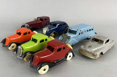 Wyandotte Marx & Tootsietoy Steel & Tin Cars: Three Tootsietoy Peugot 201 cars on ornage, one green, and one red. Wyandotte light blue Greyhound bus. Marx Chrysler airflow, Wyandotte sedan. Cadillac grey friction car with windshield wipers that w