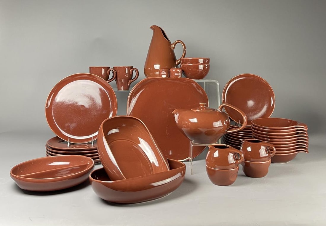 44 Pieces Russel Wright for Oneida Dinnerware Set: Classic midcentury modern design by Russel Wright. This dishware set for Oneida in Bean Brown manufactured circa 2002-2003. Includes: (1) 11" pitcher, (1) 15" chop plate, (2) 12" oval serving bowls, (