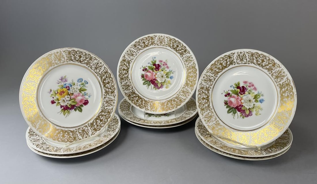 9 Charles Ahrenfeldt Limoges Dinner Plates: (9) 10" French porcelain dinner plates from Charles Ahrenfeldt for the Cowell & Hubbard Co. of Cleveland, Ohio. circa late 19th-early 20th century. Colorful floral medallions signed "Mireille" with or