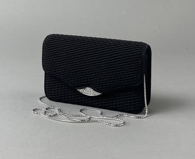 Judith Leiber Satin Minaudiere Clutch Swarovski: A formal minaudiere evening clutch in textured black satin with a Swarovski crystal clasp. The chain is removable. 6-1/2" x 4" x 1-3/4" CONDITION: There is one crystal missing on the clasp. SHIPPING: