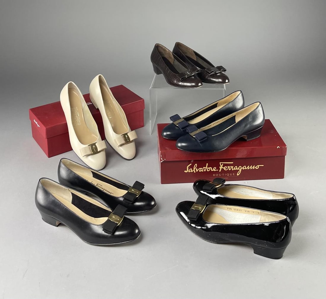 5 Pairs Ferragamo Classic Pumps 7B Lillaz, Vara: Includes 4 pairs of classic Ferragamo Lillaz pumps and 1 pair and one pair of Ferragamo Vara pumps in navy blue. 4 pairs are in size 7B, the bone pumps 7C. Original boxes included. CONDITION: Very lig
