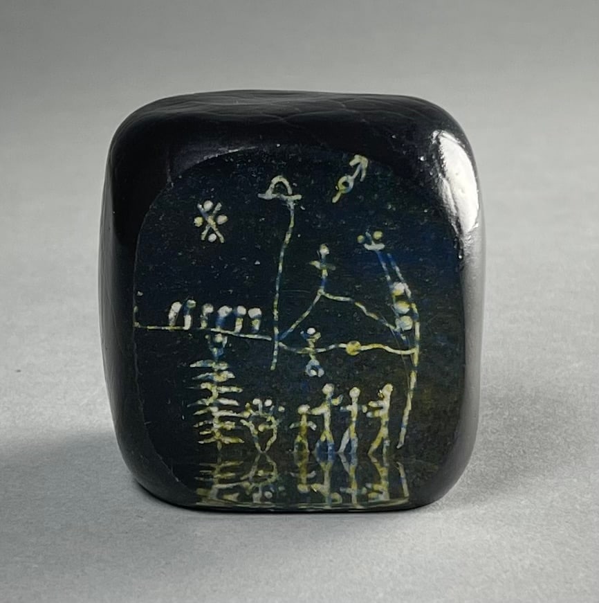 Goran Warff Kosta Boda Etched Glass Paperweight: Goran Warf (Swedish 1933-2022) art glass for Kosta Boda crystal petroglyph paperweight with an etched scene with figures. Circa mid 20th century H. 2-1/2". From the collection of Kenneth Beachler. SHI