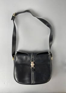 Vintage Celine Black Leather Shoulder Bag: Fold over closure with gold toned signature clasp, zippered interior compartment, adjustable shoulder strap. 10-1/2" x 9". CONDITION: Leather and gold toned hardware are quite worn. SHIPPING: In-House