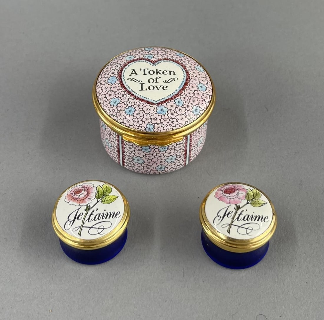 3 Halcyon Days Bilston and Battersea Enamel Boxes: 3 trinket or pill boxes, "A Token of Love" and "Je t'aime" the largest is 1" tall, 1-1/4" in diameter. SHIPPING: In-House Shipping Available for this lot. Please read our Shipping Terms and Conditions
