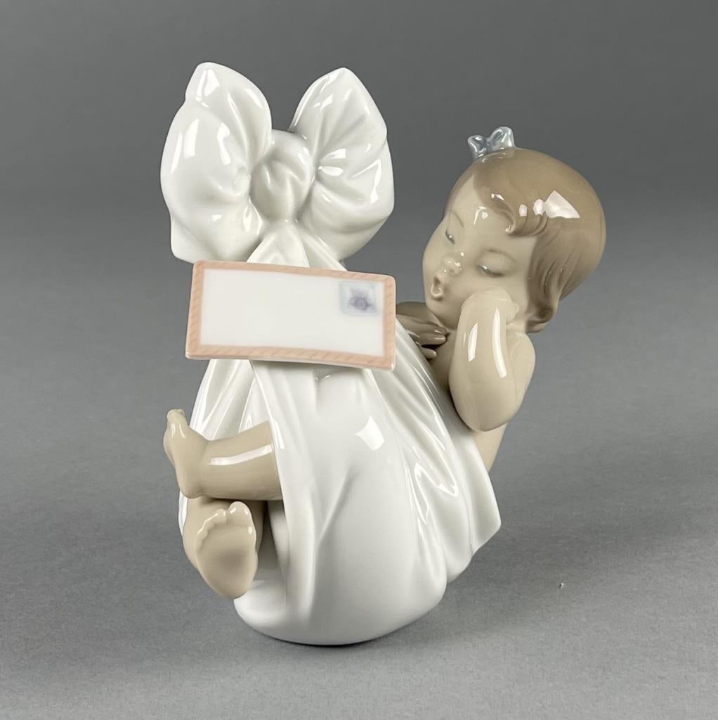 Lladro "Heaven's Gift" Porcelain Baby Figurine: Lladro baby girl figurine "Heaven's Gift". Height 4-3/4". SHIPPING: In-House Shipping Available for this lot. Please read our Shipping Terms and Conditions and Shipping Policies prior to bidding in th