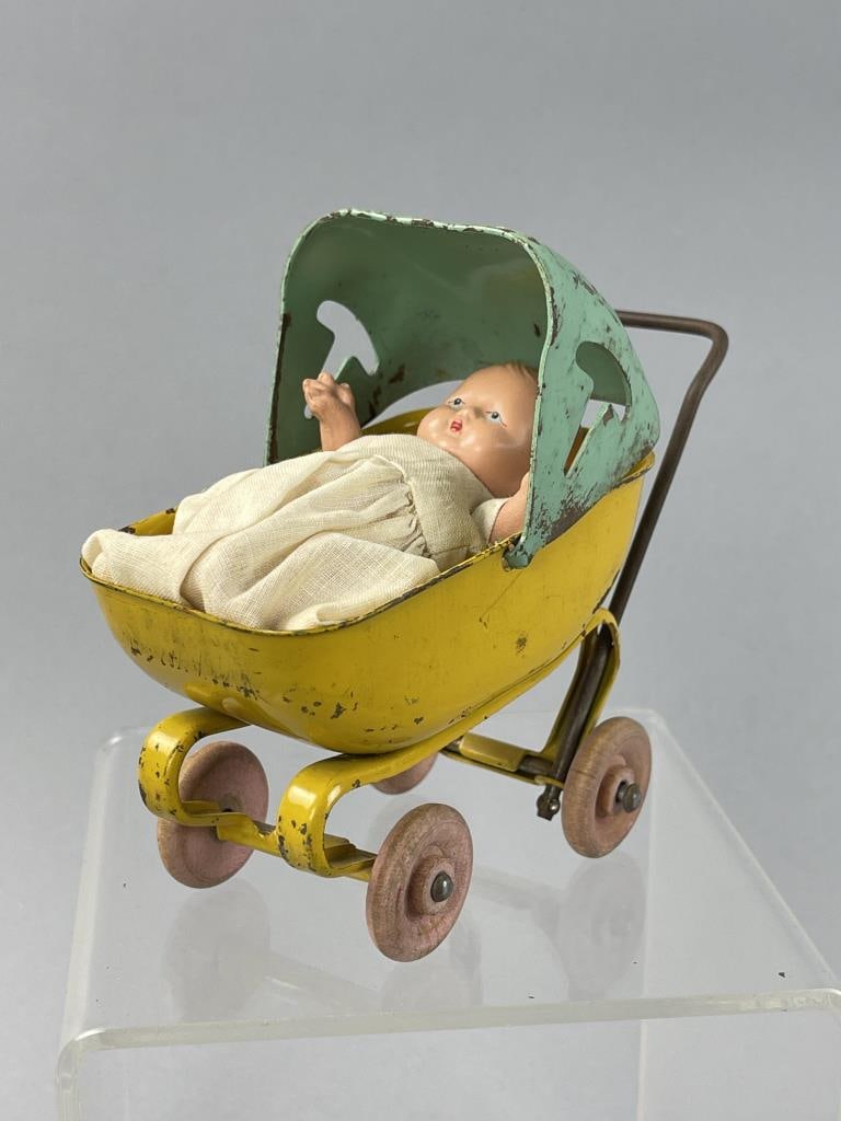 Pressed Steel Baby Carriage w/Story Book Doll: Small jointed baby with white dress, star hands, marked Story Book Doll USA on back.Possily 1930s circa Wyandotte pressed steel stroller. SHIPPING: In-House shipping available. Please read our Shippin