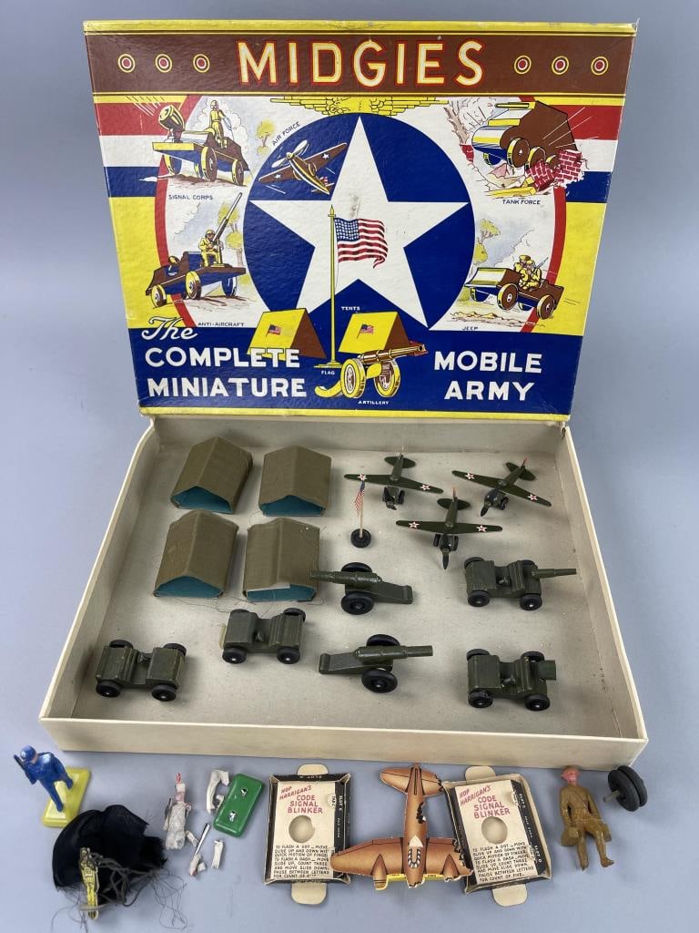 Midgies Mobile Army 14-Piece Set in Original Box: Jaymar Specialty Co. miniature army set in box. 4 tents, 3 planes, 2 jeeps, 2 cannons, 1 jeep with spot light and 1 jeep with gun and 1 American Flag included in 14 piece set. Extra pieces not part of