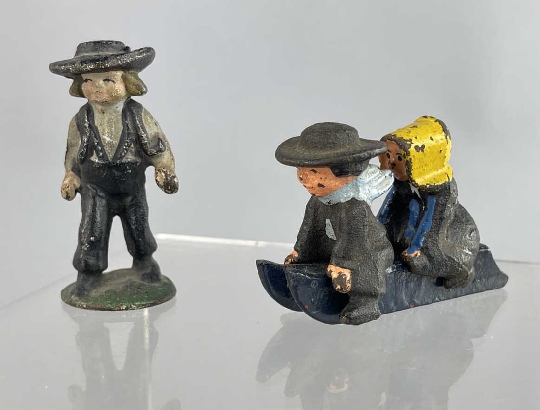 Cast Iron Hand Painted Figurines: Standing boy, boy and girl on sled. John Wright SHIPPING: In-House shipping available. Please read our Shipping Policies prior to bidding.