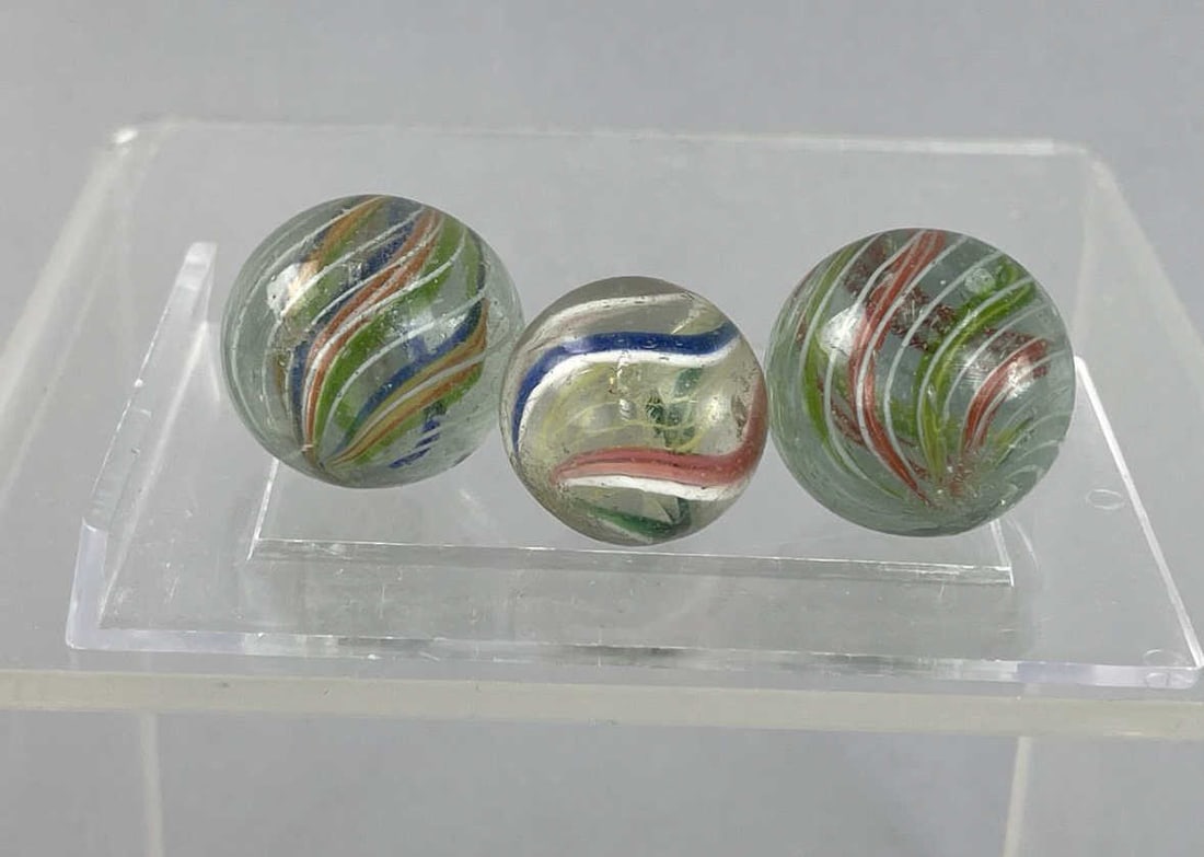 Vintage Swirl Ribbon Latticino Marbles: Three vintage marbles. 7/8 inch and 1 inch in sizeDivided core swirl SHIPPING: In-House shipping available. Please read our Shipping Policies prior to bidding.