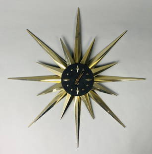 1957 Ellerman Key Wound Sunburst Wall Clock: F.G. Ellerman midcentury modern sunburst /starburst clock. It has a key wound movement marked "Made in France" and includes its key. Primarily made of plastic with some metal components. Measures 34-1