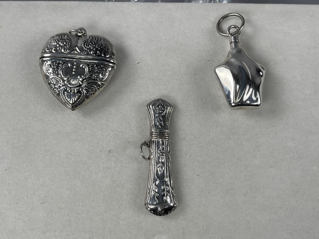 Silver Chatelaine Perfume Toothpick Snuff Boxes: Sterling silver 2 1/2'' REO needle case, marked REO STERLING, 10.00 grams. Sterling silver 2'' heavy engraved heart trinket snuff box, marked 925, 15.03 grams.Sterling silver 2'' perfume bottle, marke