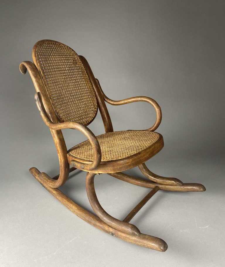 Thonet Child's Bentwood Rocking Chair: Child's bentwood and cane rocking chair, designed by Michael Thonet (German Austria 1796 - 1871), marked on underside, 24" tall. SHIPPIN
