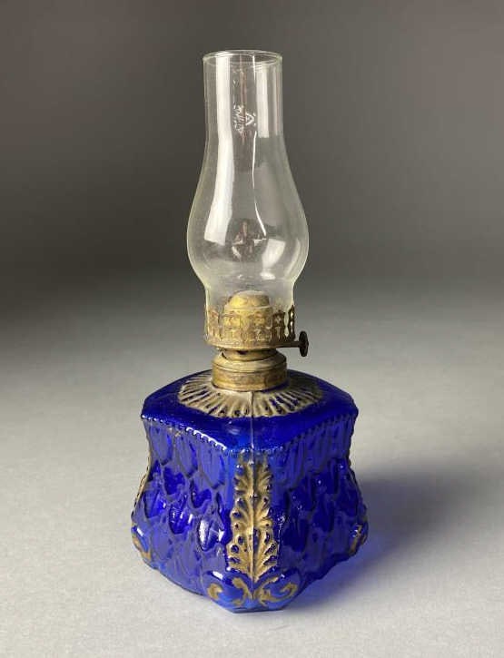 Mini Oil Lamp Molded Cobalt Glass 1880s: Mini oil lamp with a molded cobalt glass font with gold painted accents, circa 1880s, 9-1/2" tall. SHIPPING: In-House Shipping Available