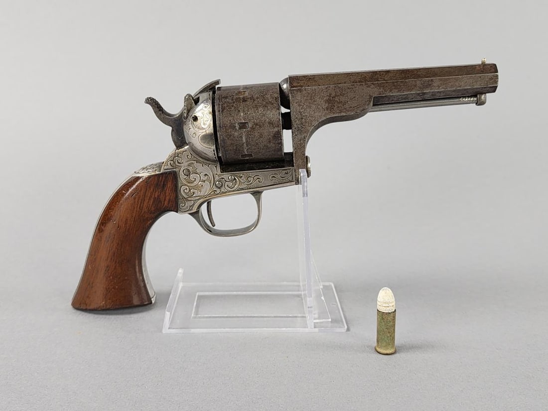 Moore's 1860 .32 Cal. Rimfire With 1 Single Round: First gun to feature swing out, this revolver has serial # 2957 and has 1 original unfired round with it