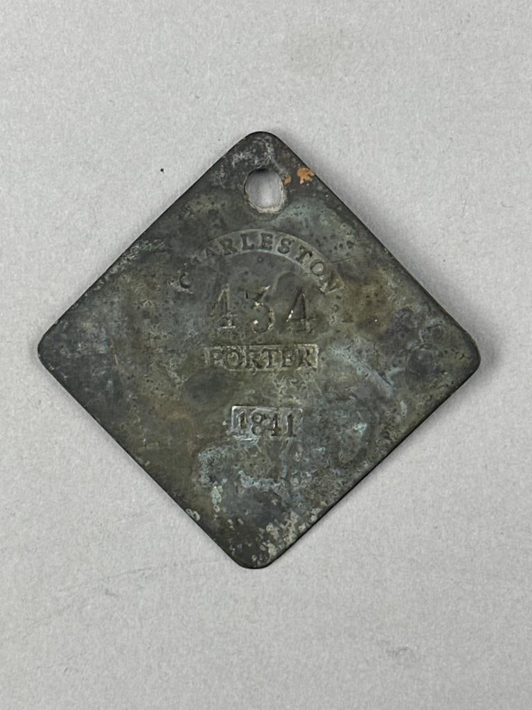 1841 Charleston SC Servant Slave Tag: 1841 Copper servant / slave tag Charleston, South Carolina stamped: "Charleston 434 Porter 1841". 1-3/4" x 1-3/4" Diamond shaped tag as issued in odd numbered years, with clipped corners and hole punc