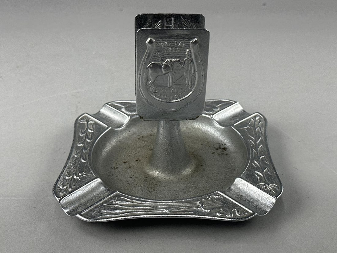 Green River Whiskey Ash Tray Matchbook Holder: Green River Whiskey "She was Bred in Kentucky" silver tone metal ashtray with central standing matchbook holder. Measures 5" x 3".