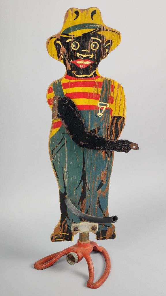 Black Americana "Sprinklin' Sambo" Lawn Sprinkler: Black Face Collectible lawn sprinkler with Some age related wear to original paint - measures approximately 26" tall and 8" wide.