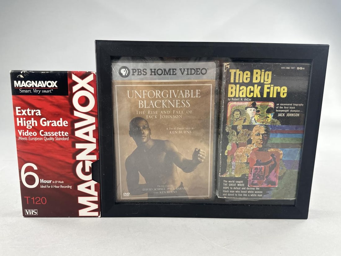Framed Set of Jack Johnson Book, DVD Video & VHS: The Big Black Fire, by Robert H. DeCoy,1969 paperback, & PBS home video DVD Unforgivable Blackness, The Rise and Fall of Jack Johnson, directed by Ken Burns, presented together in a 9" x 11" frame, fr