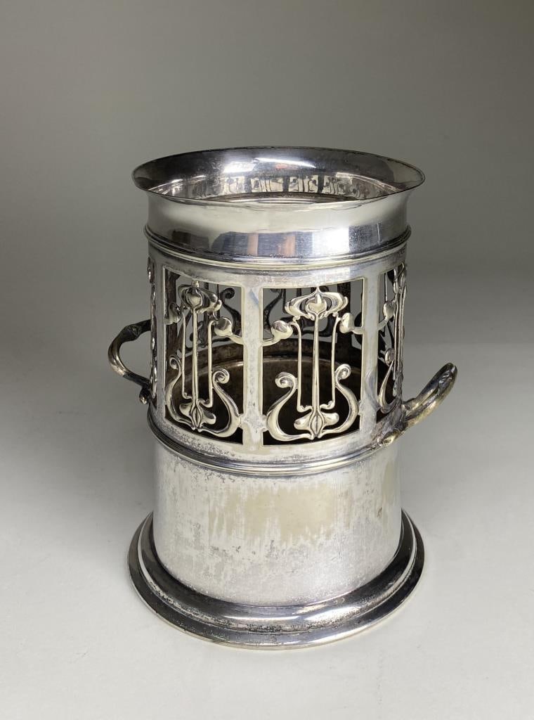 Art Nouveau Silver Wine Coaster Roberts & Belk: Circa 1900 silver plated wine bottle coaster or holder with the mark of Roberts & Belk of Sheffield England as well as that of Harrison & Son Jewellers Darlington. Height 7-3/16".