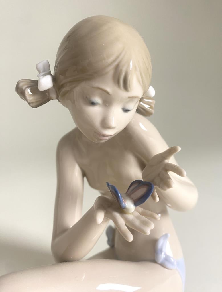 Lladro "Free as a Butterfly" Porcelain Figurine: Lladro porcelain figurine titled "Free as a Butterfly" number 1483. Height 7". SHIPPING:In-House