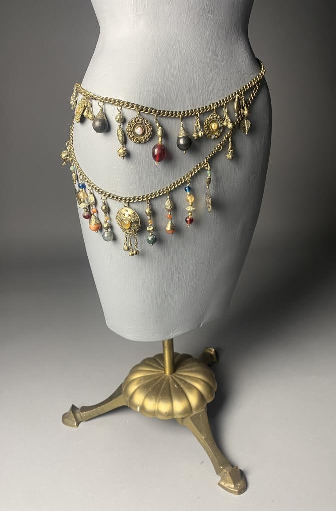 Chain Belt with Stone and Glass Charms: Belly chain style belt in brass with hand crafted gold toned charms with glass and stone beads and accents. Length 38".
