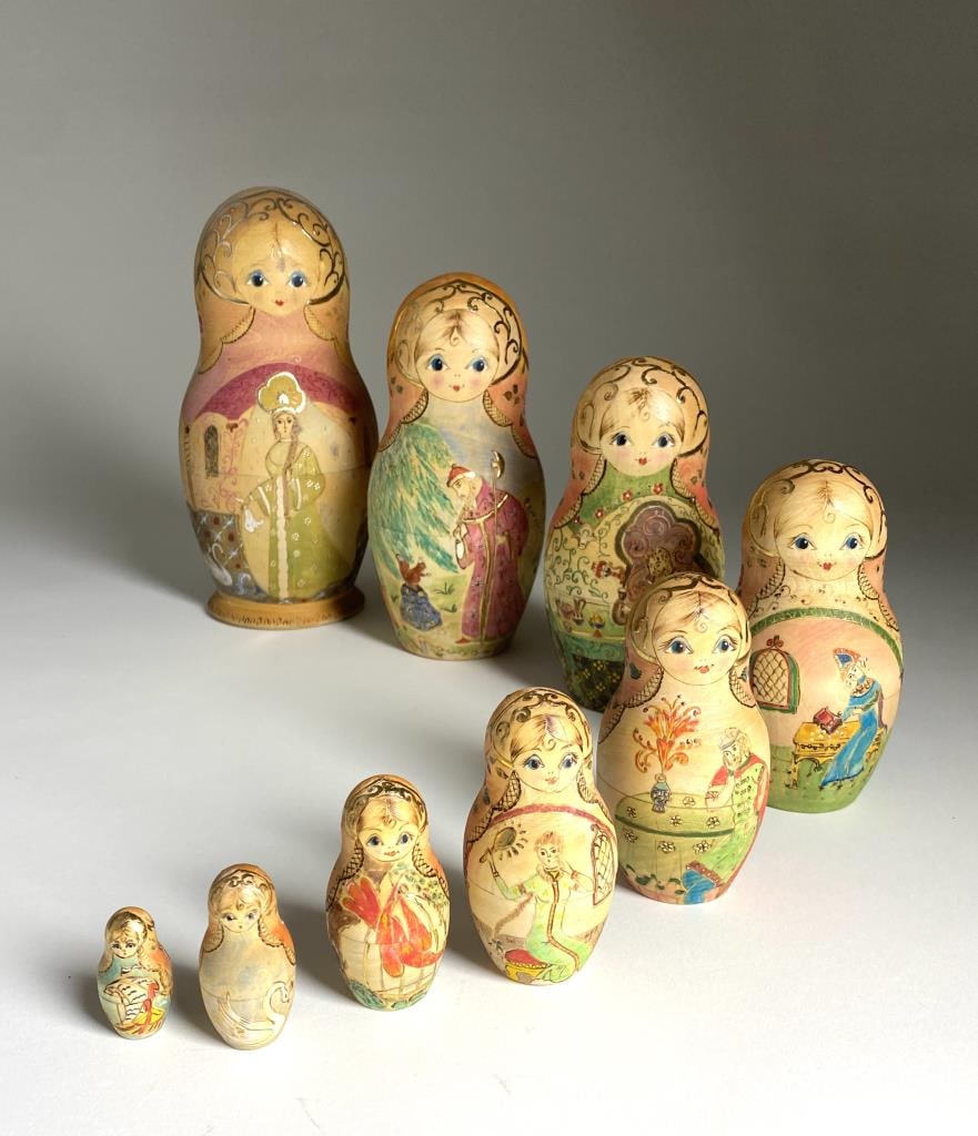 Russian Hand Decorated Nesting Doll Set: Hand engraved, painted and gilt embellished wooden 9 piece nesting doll set. The largest measures 9-1/2" the smallest 1-3/8". Artist signed as shown.