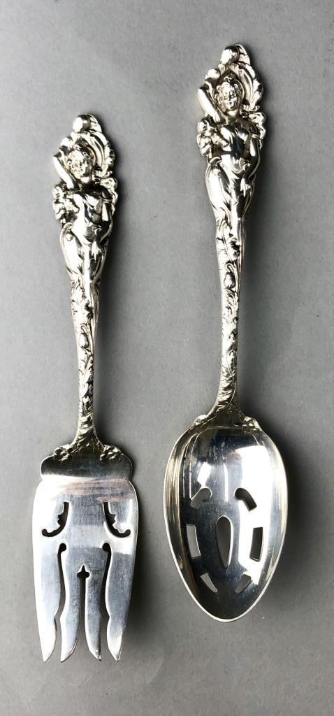Reed & Barton Love Disarmed Sterling Pieces 1899: Two sterling silver serving pieces by Reed & Barton in the pattern "Love Disarmed," introduced in 1899. The spoon, the largest piece, is 8-1/4" in length, 195 total grams for both pieces together.